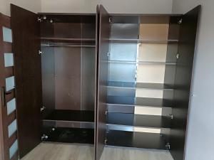 a closet with glass doors in a room at Apartament Malbork in Malbork