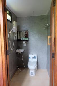 a bathroom with a toilet and a sink at Rawi Seaside Cottage, Ko Yao Noi in Ban Laem Sai +27 photos