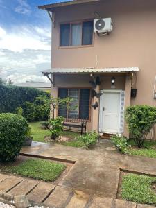a house with a bench in front of it at Modern 2BR, Sanctuary in Lusaka