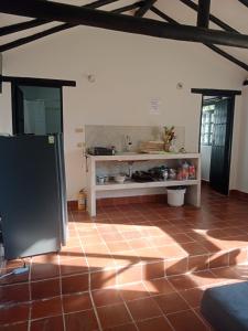 a kitchen with a refrigerator in a room at San Marcos in Villa de Leyva