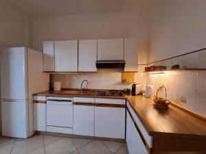 a kitchen with white cabinets and a white refrigerator at 2 Giugno House in Bari +14 photos