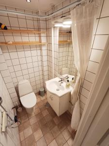 a white bathroom with a toilet and a sink at Beautiful 3 bedroom apartment in Central City in Aalborg +19 photos