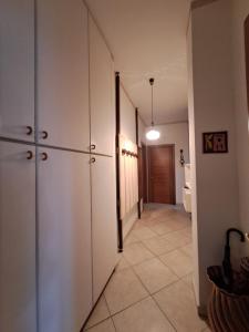 a hallway with white cabinets and a toilet in a room at 2 Giugno House in Bari