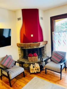 a living room with two chairs and a fireplace at NEW on Bkg! NuovaGrangia Confortable for 2 Families in Grange Sises