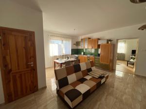 a living room with a couch and a kitchen at BALU CITY APARTMeNT in Dunajská Streda