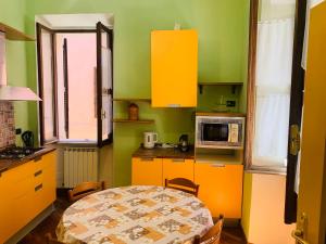 a small kitchen with a table and a microwave at L'Archetto Apartment in Rieti