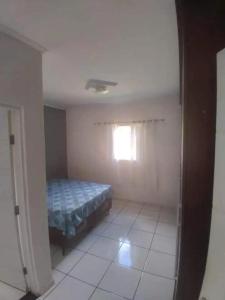 a bedroom with a bed and a window at Chácara bela vista in Socorro +40 photos