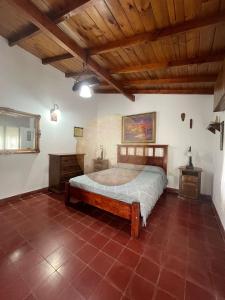 a bedroom with a bed and a wooden ceiling at Casa Ganesha Chapadmalal in Chapadmalal +11 photos