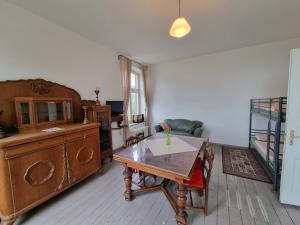 a living room with a table and a dresser at Ferienwohnung Maria im alten Pastorat in Kevelaer