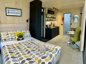 a bedroom with a bed and a kitchen at Ewe and Me Glamping in Northallerton