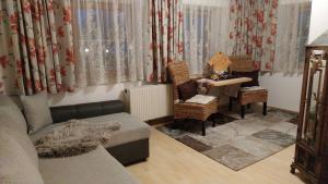 a living room with a couch and a table at Thalerhof in Roppen