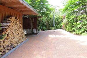 a pile of fire wood next to a building at Strandhaus Möve in Wustrow