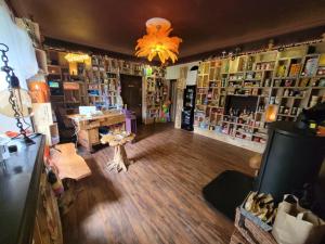 a room with a store with a room with bookshelves at Budget stay, in lovely private setting with rustic charm, log burner, fire pit, campers kitchen & Eco Loo NO BEDDING SUPPLIED in Narberth