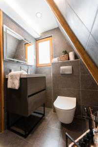a bathroom with a sink and a toilet at Paplanka Boutique Cabin in Nyírbátor +20 photos
