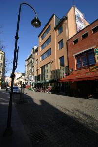 a street light on a city street with buildings at Ruby Blue in Ostrava