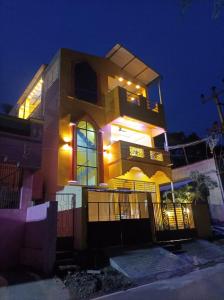 a house with lights on top of it at night at Seasons4 Homestay in Virāmpattinam