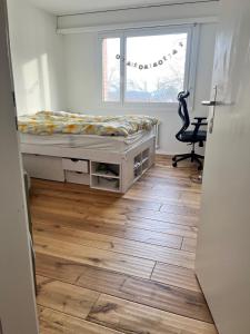 een slaapkamer met een bed, een bureau en een raam bij Green Basel Home in Binningen +9 foto's