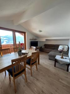 a living room with a table and chairs and a couch at Bio-Bergbauernhof Hubgut in Zell am See