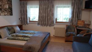 a living room with a bed and a couch at Thalerhof in Roppen