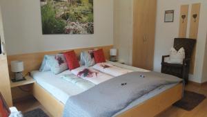 a bed with pillows on it in a room at Thalerhof in Roppen