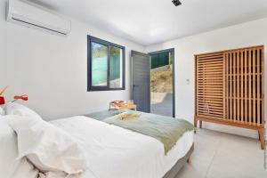 Ένα ή περισσότερα κρεβάτια σε δωμάτιο στο Villa Casalta - Vue Mer Caraïbes