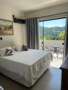 Postel nebo postele na pokoji v ubytování Pousada Monte Verde