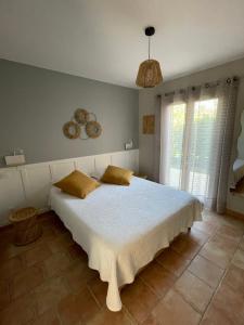 ein Schlafzimmer mit einem großen weißen Bett mit gelben Kissen in der Unterkunft Chez Francis & Valérie in Villegailhenc + 56 Fotos