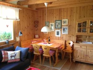 a kitchen and dining room with a wooden table and chairs at Ferienhaus Bruno - Südhanglage mit 2 Schlafzimmern in Feldberg +16 photos