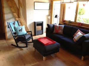 a living room with a couch and a chair at Ferienhaus Bruno - Südhanglage mit 2 Schlafzimmern in Feldberg