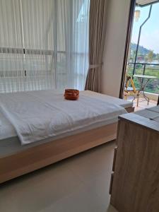 a bed in a room with a large window at Anagata House-villa 3BR at C8 Grand Kusuma Hill in Batu