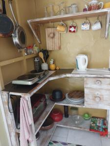 eine Küche mit einer Theke mit Tellern und Pfannen in der Unterkunft SHAMBHALA Homestays Cottage and Studio in Christchurch + 20 Fotos