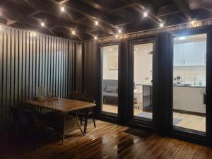 a dining room with a table and a kitchen at Tiny House in Alytus