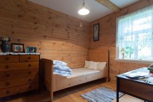 a wooden room with a bed and a window at beautiful cosy Country Cottage Heaven only for You in Nowy Berezów