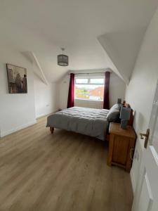 a bedroom with a bed and a window at Luxury Coastal Retreat, Sleeps 6, Free WiFi, Free Parking, Detached in Donaghadee