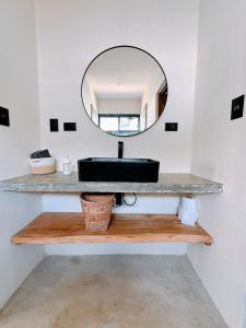 a bathroom with a sink and a mirror at Casa Ola, luxurious jungle house in El Valle