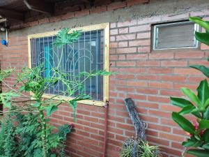 a brick building with a window and a fence at Claudia Apart in Wanda