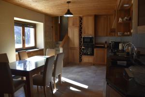 a kitchen with a table and chairs in a room at La casa Chiappelle in Cortemilia
