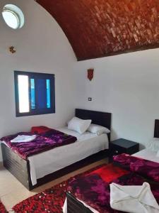Postel nebo postele na pokoji v ubytování Kemet Nubian GUEST House