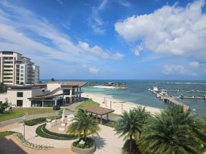 a view of a beach with palm trees and buildings at Apartamento Playa Escondida Marina & Resort in María Chiquita