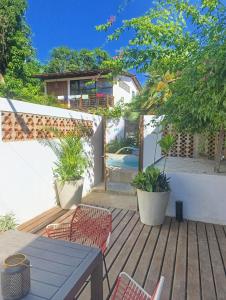 a patio with a table and chairs on a deck at Casas La Floristería in Palomino +72 photos