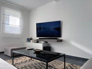 a living room with a tv and a coffee table at Apartment Spanjol in Banjol