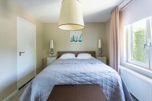 Un pat sau paturi într-o cameră la Cottage Heuvelland