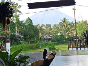 a table with a view of a mountain at Indah Damai Cottages in Sidomukti