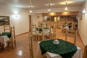 a dining room with green tables and chairs at Mini-hotel Tikhaya Gavan in Kyrylivka