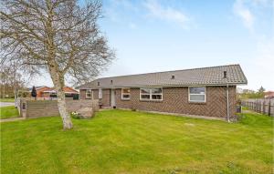 a brick house with a tree in a yard at Nice Apartment In Bindslev With Wifi in Bindslev