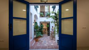 a door leading to a hallway with plants at Veranera Hostel in Estepona