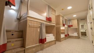a room with three bunk beds in it at Veranera Hostel in Estepona