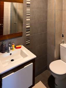 a bathroom with a white sink and a toilet at Blanca beach in Sidi Rahal