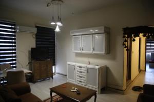 a living room with a couch and a table at Karada Abu Nawas private room in Baghdad