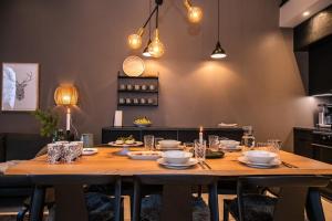 a wooden table with plates and dishes on it in a kitchen at Villa Havu A in Syöte